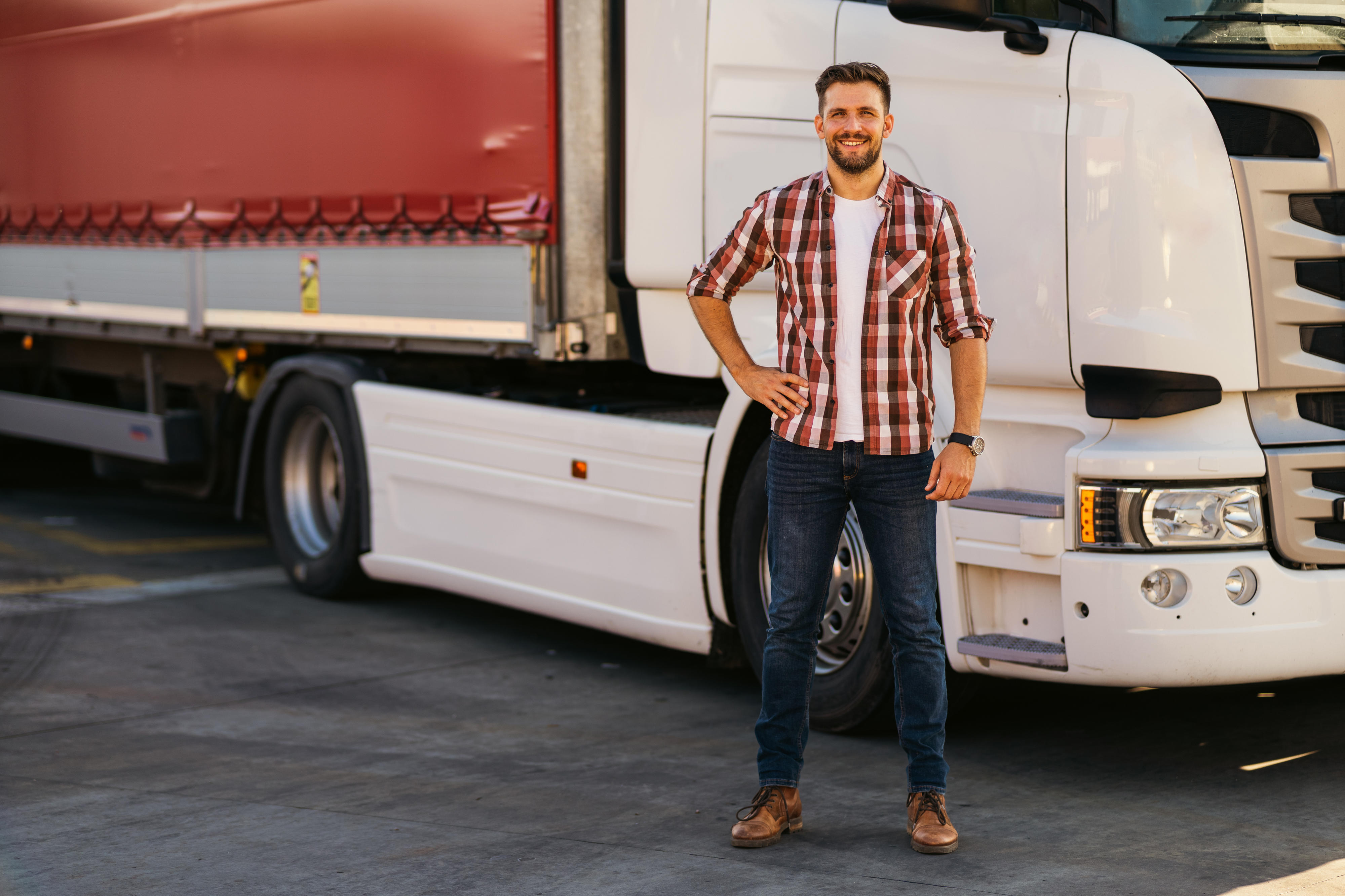 Driver standing next to his truck